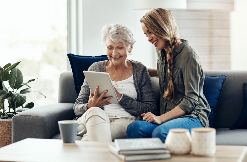 Tablet,,Sofa,And,Woman,Relax,With,Senior,Mother,In,Home